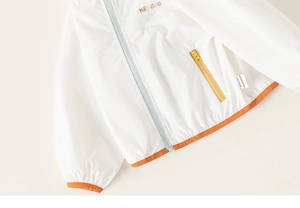 Detail of kids white sun-protective jacket with colorful embroidery and orange elastic trim