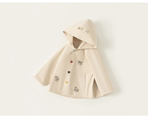 Detail of baby hooded cloak with colorful buttons and cute animal embroidery