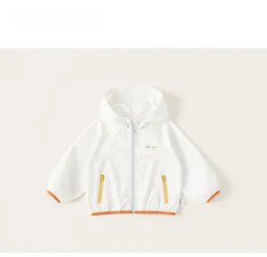Detail of kids hooded windbreaker with colorful zippers and contrast orange hem binding