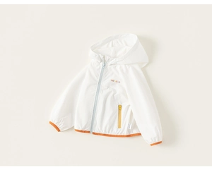 Close-up of kids hooded windbreaker featuring colorful embroidery and contrast orange edging