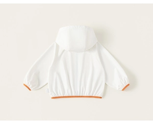 Detail view of children's white hooded jacket featuring orange elastic cuffs and back design