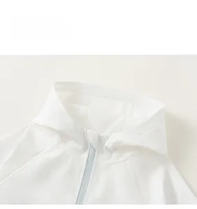 Close-up of white hooded kids jacket featuring a light blue zipper and woven texture