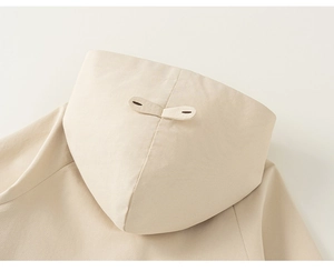 Detail of hood strap on beige toddler jacket with high-quality twill fabric texture
