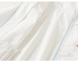 Close-up of white sun protection jacket showing zipper detail and neat stitching quality