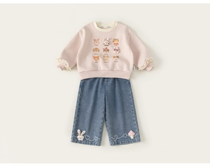 Dettagli della felpa rosa con polsini in pizzo e jeans blu con ricamo a forma di coniglio