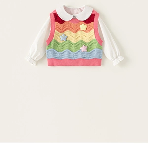 Detail of white polka dot shirt with Peter Pan collar and rainbow striped knitted vest