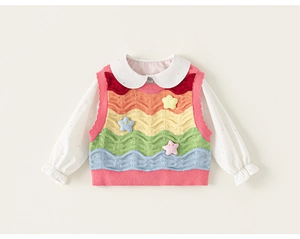 Close-up of rainbow knit vest with star patches and white dotted Peter Pan collar shirt