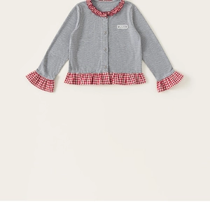 Detail of grey knitted cardigan for girls with red checkered ruffle trim and button closure