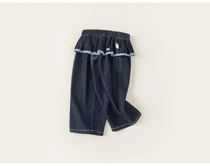 Detail of girls denim jeans with elastic ruffled waist and blue gingham check trim