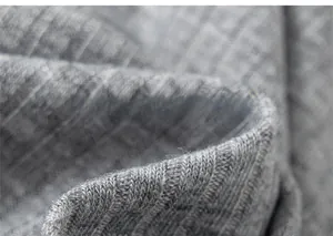 Close-up of grey ribbed knit cotton fabric showing soft texture and elastic vertical stripes
