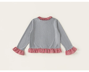 Detail of grey waffle knit fabric with red gingham ruffle trim on girl's long sleeve top