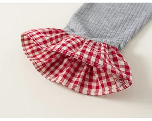 Detail of grey ribbed knit sleeve with red gingham ruffle cuff for girls T-shirt