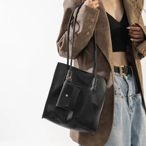 Minimalist black lychee leather tote bag for women with matching small pouch and shoulder strap