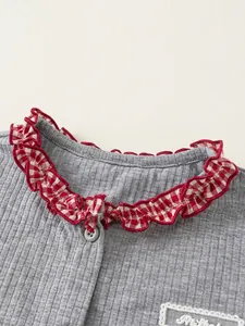 Girls grey ribbed knit top with red plaid ruffled collar and button detail
