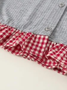 Girls' grey ribbed top with red gingham ruffle trim and decorative matte buttons
