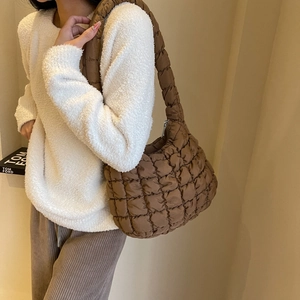 Close-up of brown quilted bubble shoulder bag featuring soft textured padded fabric