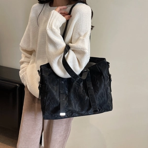 Minimalist large black PU leather tote bag with pleated texture and wide shoulder strap