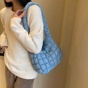Detail shot of the blue quilted puff shoulder bag showing the unique soft bubble texture