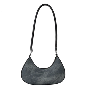 Minimalist grey denim hobo bag with black leather shoulder strap and crescent moon shape