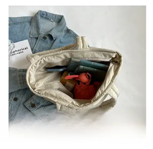 Interior view of large capacity quilted tote bag showing space for phone and umbrella