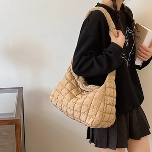 Minimalist beige quilted shoulder bag with soft padded design for winter style