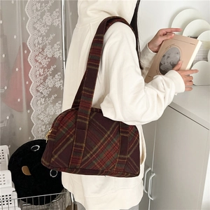 Close-up of retro plaid shoulder bag in burgundy and brown wool with wide strap