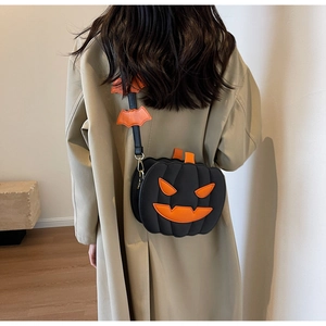 Detail view of the Halloween pumpkin shoulder bag on a model wearing a beige trench coat