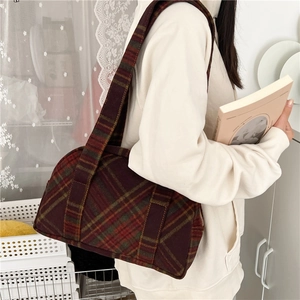 Detail shot of the vintage plaid wool shoulder bag with classic autumn patterns