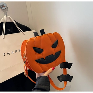 Detailed view of pumpkin-shaped Halloween crossbody bag with black bat wings and PU leather