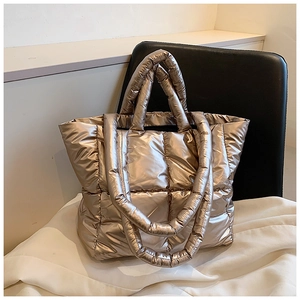 Metallic gold quilted puffer tote bag with large square stitching and dual handles