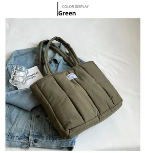 Detail of olive green quilted puffer tote bag with brand label on denim jacket