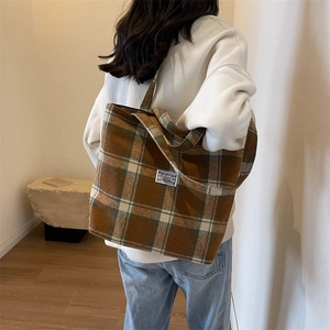 Close-up of thick plaid wool tote bag with textured brown and beige checkered fabric