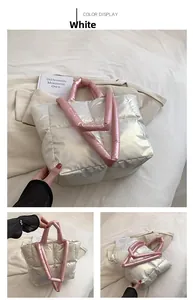 Quilted silver puffer tote bag featuring soft pink padded handles and crossbody strap