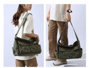 Detail view of large canvas crossbody bag with multi-pocket design and adjustable strap