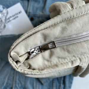 Minimalist beige quilted down tote bag with high-quality zipper detail for women