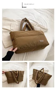 Dettaglio di una borsa tote marrone trapuntata con manici morbidi imbottiti
