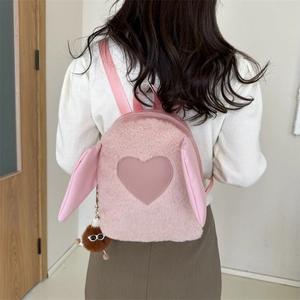 Back view of a mini pink plush backpack featuring cute rabbit ears and a heart patch detail