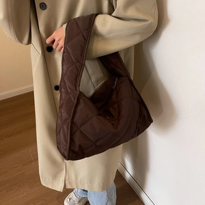 Deep coffee quilted shoulder bag in high-quality fabric showing texture and fit on model