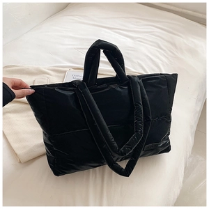 Détail du grand sac cabas matelassé noir brillant avec deux options de bandoulière