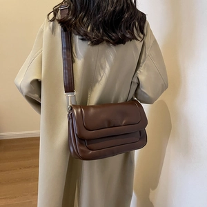Detailed back view of a minimalist brown plaid PU leather crossbody bag with wide strap