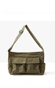 Front view of an olive green canvas messenger bag with adjustable shoulder strap and pockets