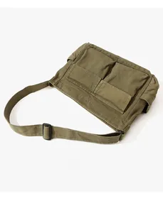 Top view of olive green canvas messenger bag with dual square pockets and wide strap