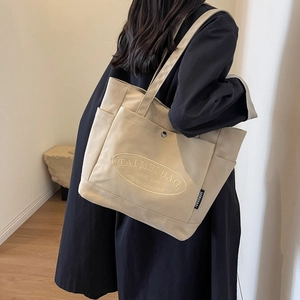 Chic beige plaid canvas tote bag for women with dual handles and front pocket