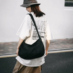 Minimalist black nylon crossbody crescent bag for women, ideal for street style and commuting