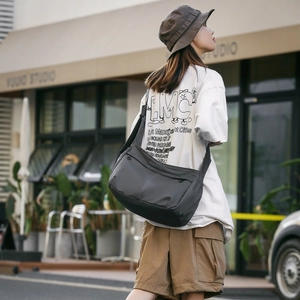 Detailed view of gray nylon messenger bag featuring waterproof fabric and adjustable strap