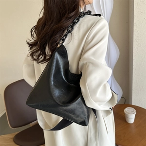 Detail of black large capacity shoulder bag with soft pleated leather and chain strap