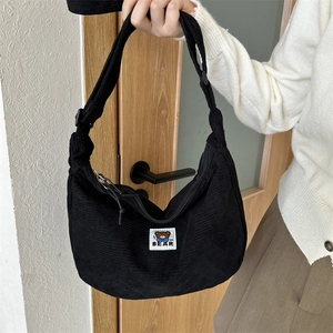 Minimalist black corduroy crescent shoulder bag with bear patch for casual daily styling