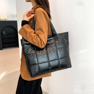 Chic black quilted puffer tote bag for women featuring large capacity and soft padded nylon