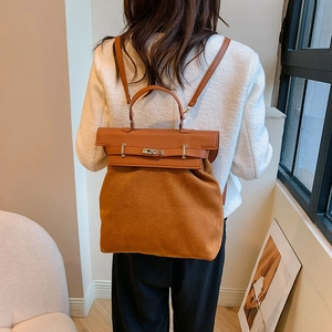 Detail of the vintage brown suede and leather patchwork backpack with gold buckle