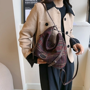 Détail d'un sac à main en laine à carreaux d'hiver avec bandoulière et emblème mode